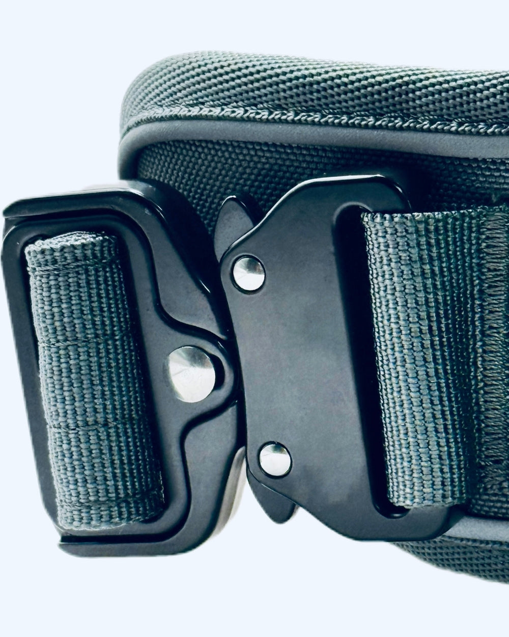 Close-up of a green belt with a black buckle on a white background