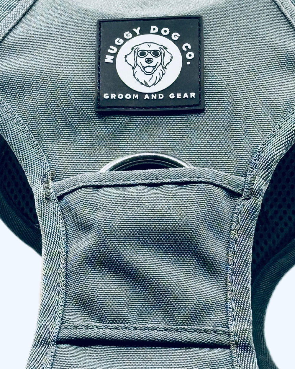 Gray dog grooming vest with Nuggy Dog Co. logo on a gray background