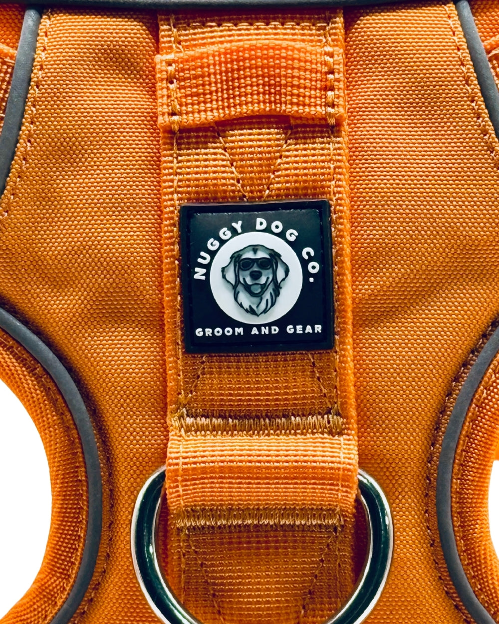 Orange dog harness with a Nuggy Dog Co. label on a white background