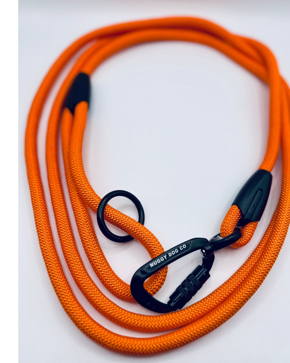 Orange dog leash with black carabiner on a white background