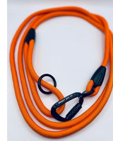 Orange dog leash with black carabiner on a white background